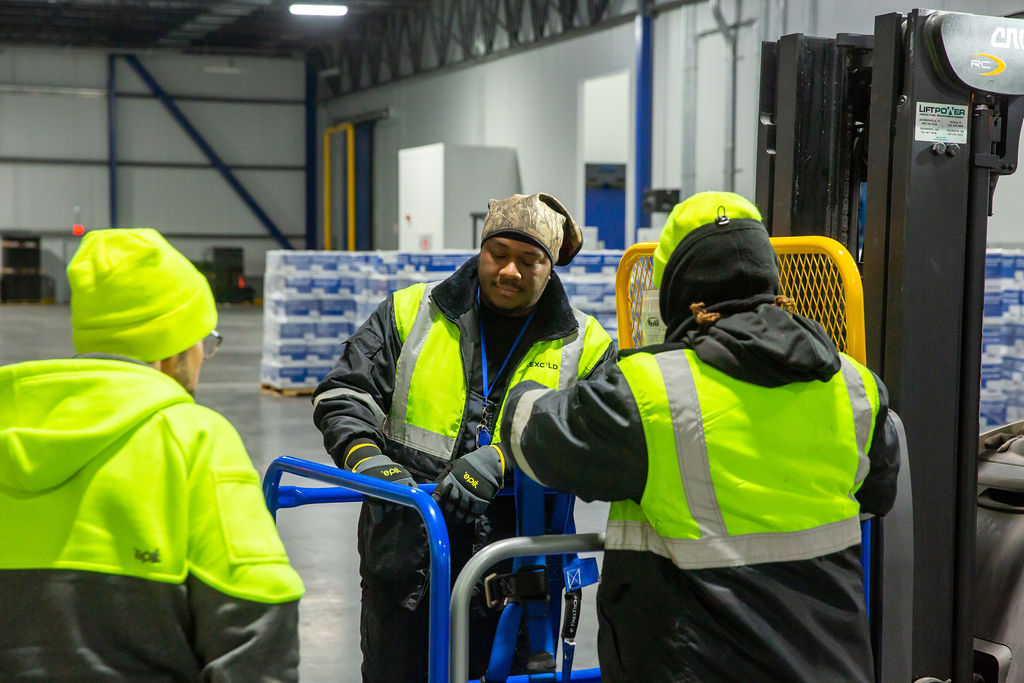 Cold storage warehouse teammates working together on the warehouse doc.