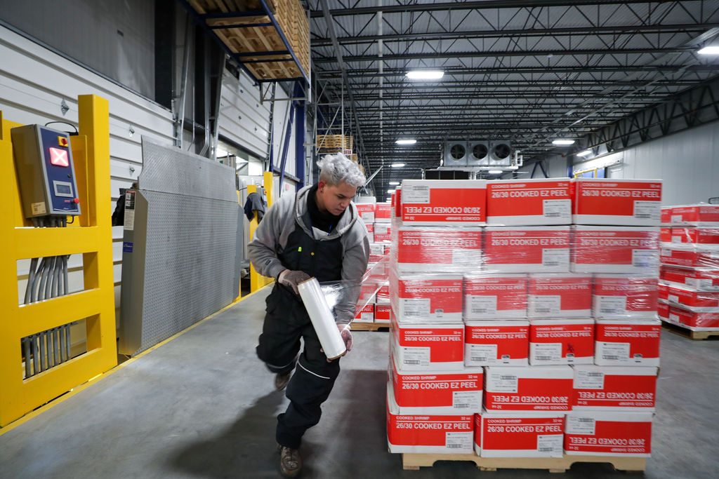 FlexCold teammate wrapping product on a pallet.